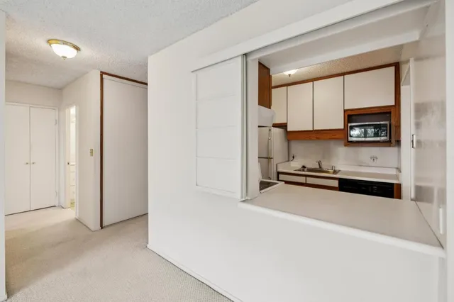 a kitchen with stainless steel appliances a refrigerator sink and white cabinets