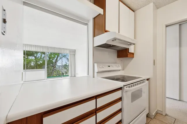 a kitchen with a sink and a stove top oven