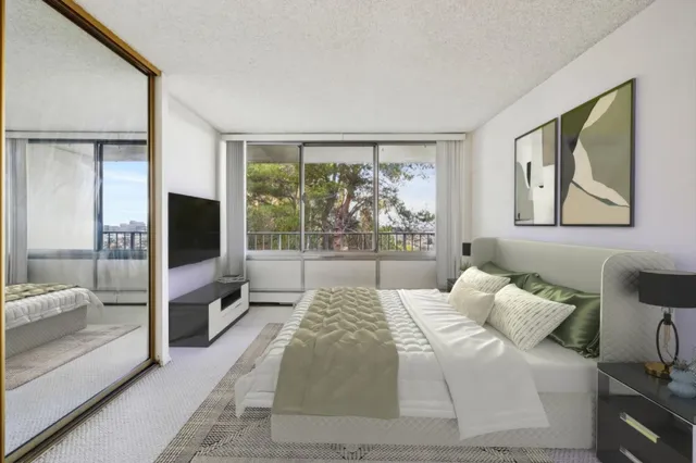 a bedroom with a balcony a bed and a television