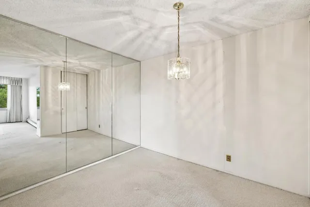 a view of a chandelier fan and entryway