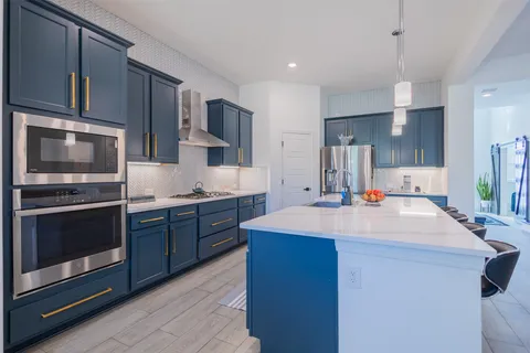 a kitchen with stainless steel appliances a sink stove and microwave