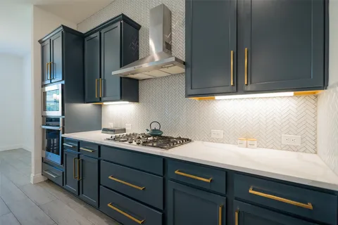 a kitchen with a sink cabinets and stainless steel appliances