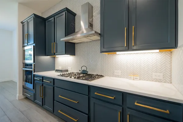 a kitchen with a sink cabinets and stainless steel appliances
