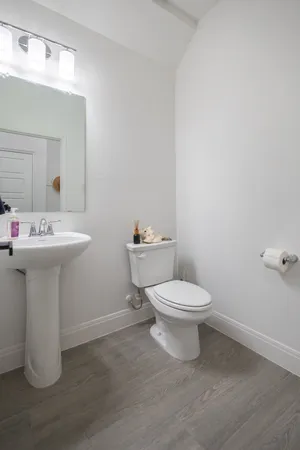 a bathroom with a sink toilet and a mirror