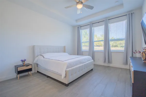 a bedroom with a bed and a chandelier