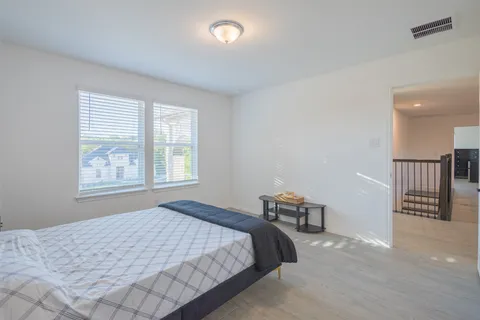 a bedroom with a bed and window