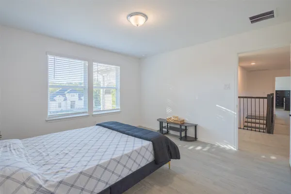 a bedroom with a bed and window