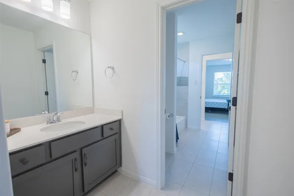 a en suite bathroom with a sink a mirror and a shower