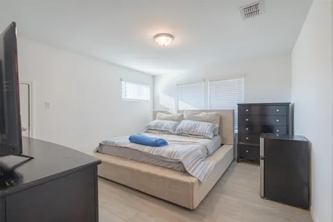 a bedroom with a bed and a flat screen tv