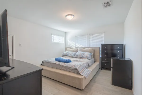 a bedroom with a bed and a flat screen tv