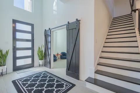 a view of entryway with stairs and a rug