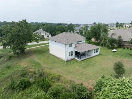 an aerial view of a house with a garden and yard