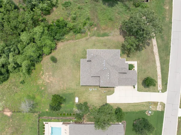 an aerial view of a house with a yard