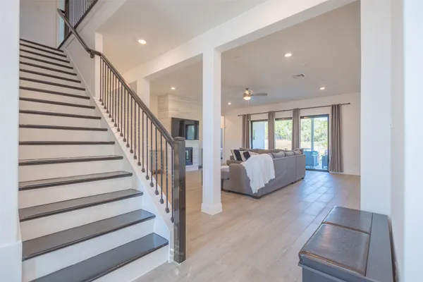 a view of an entryway and hall with wooden floor