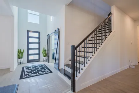 a view of entryway with stairs and wooden floor