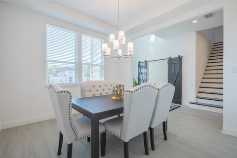 a view of a dining room with furniture and window