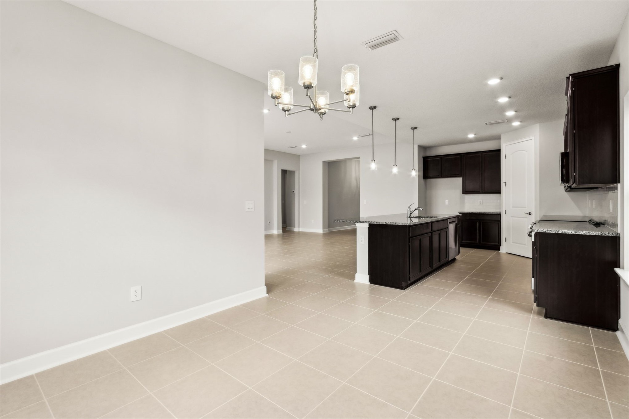 85236 Sandy Rdg Loop Yulee, FL 32097 - Photo 6 of 19 a view of a kitchen with a sink and a chandelier