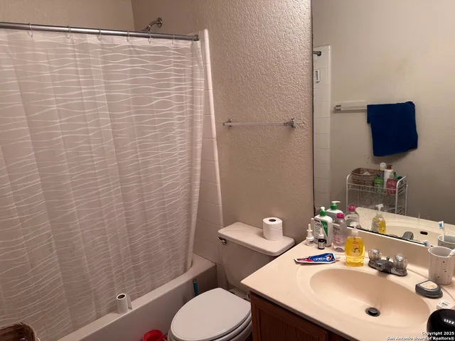 a bedroom with a bed and painting on the wall