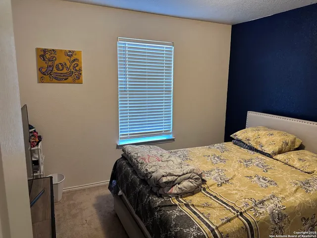 a bedroom with a bed and a mirror