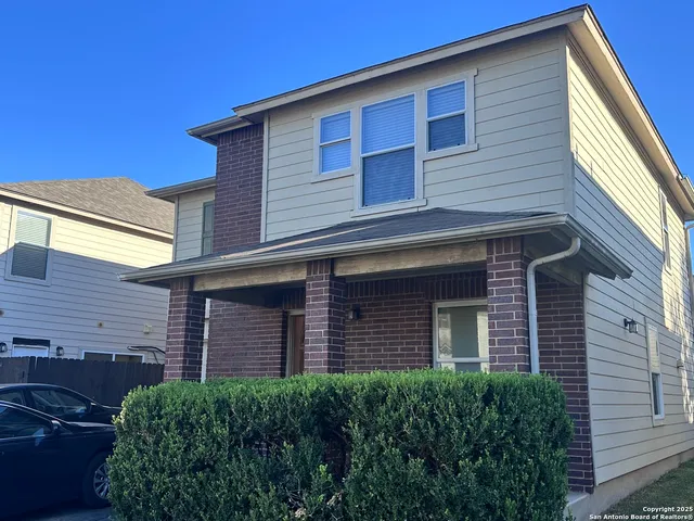 a brick house with a small yard