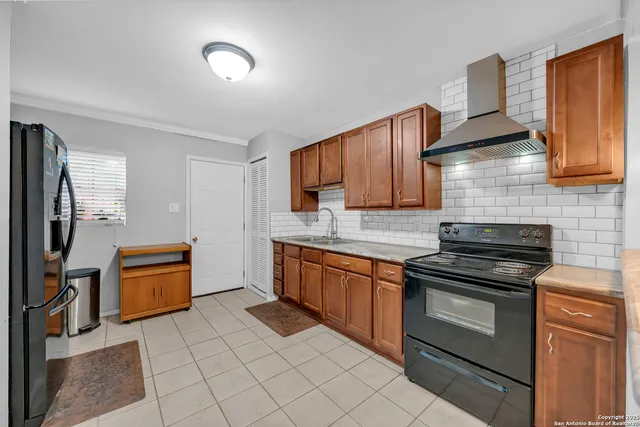 a kitchen with granite countertop stainless steel appliances and wooden cabinets
