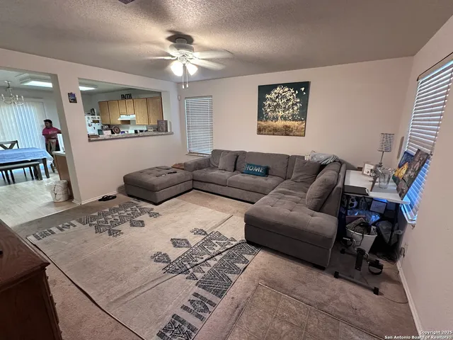 a living room with furniture a bed and a flat screen tv