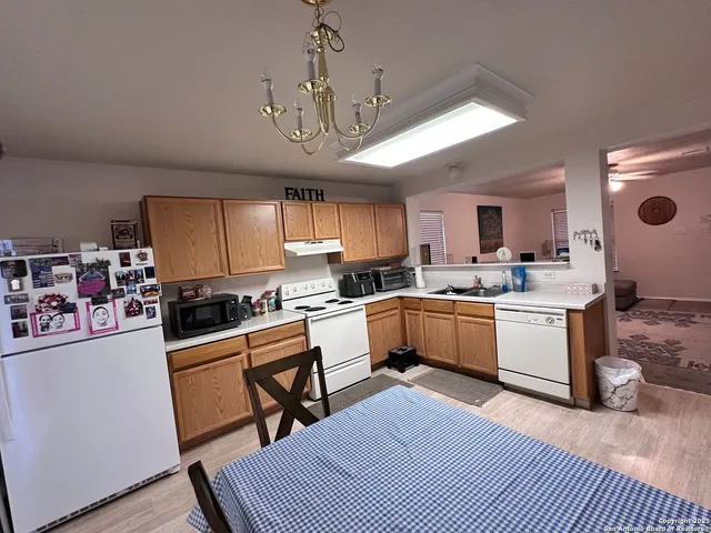 a kitchen with a sink a counter top space stainless steel appliances and cabinets