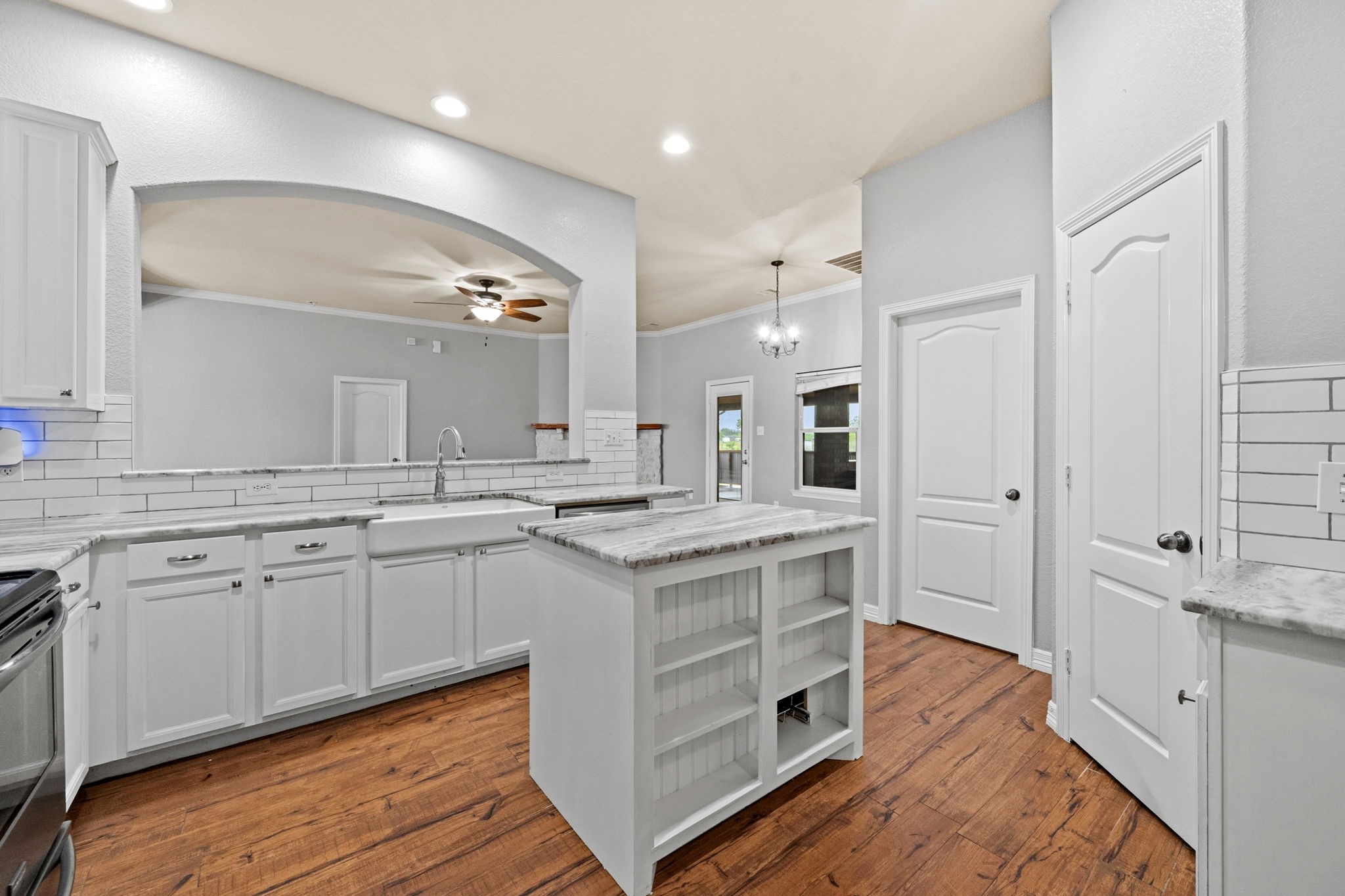 1405 Big Hill Road Winnie, TX 77665 - Photo 26 of 43 a large kitchen with cabinets wooden floor and stainless steel appliances