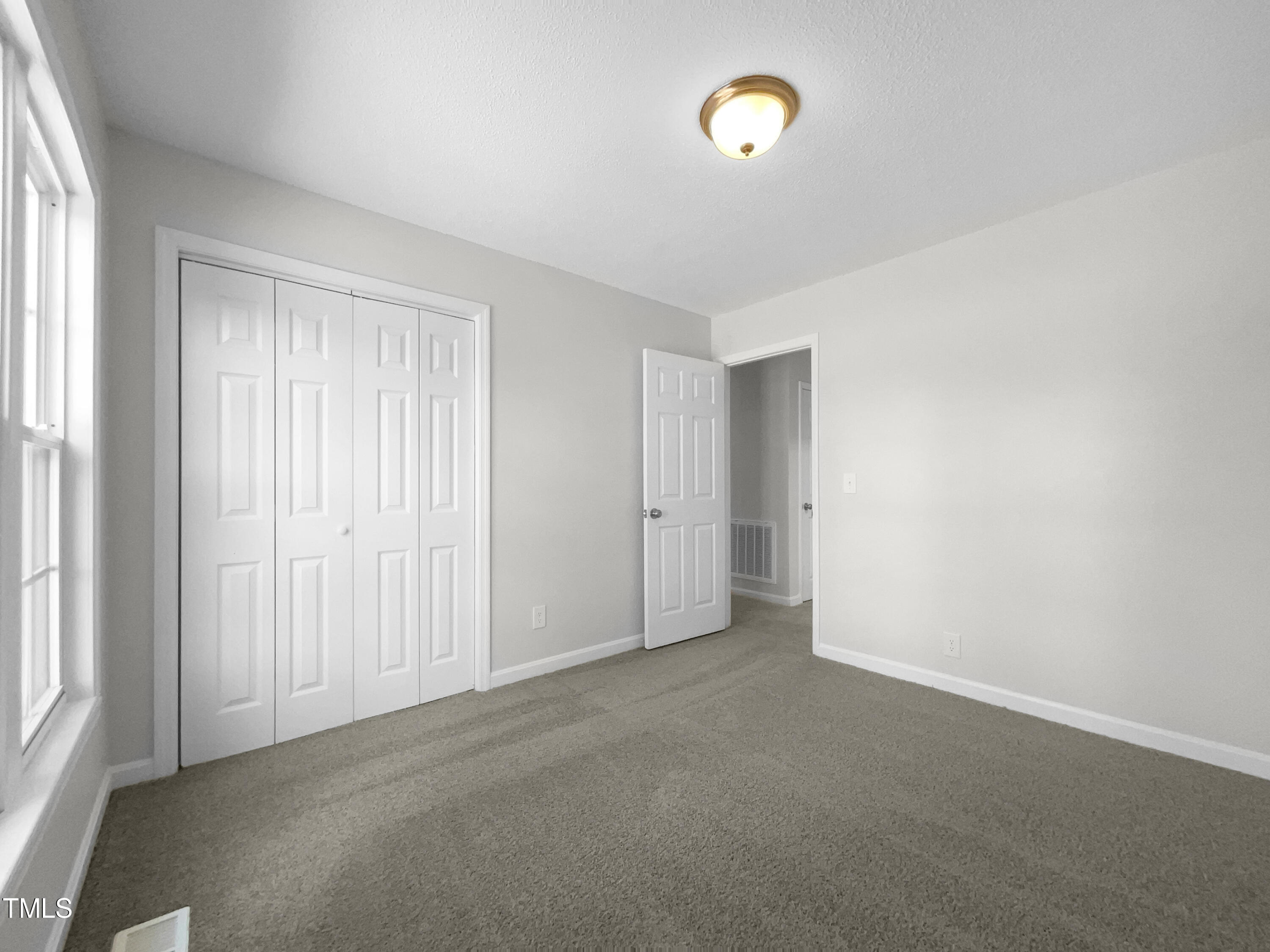 1516 Clayton Road Fuquay-Varina, NC 27526 - Photo 14 of 17 an empty room with windows and closet