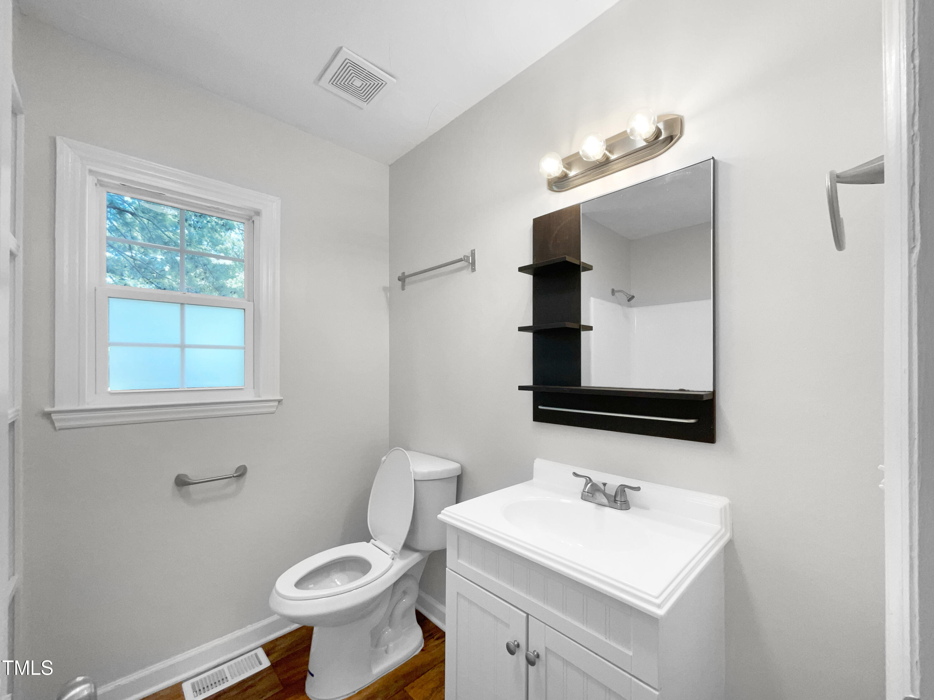 1516 Clayton Road Fuquay-Varina, NC 27526 - Photo 15 of 17 a bathroom with a toilet sink and mirror