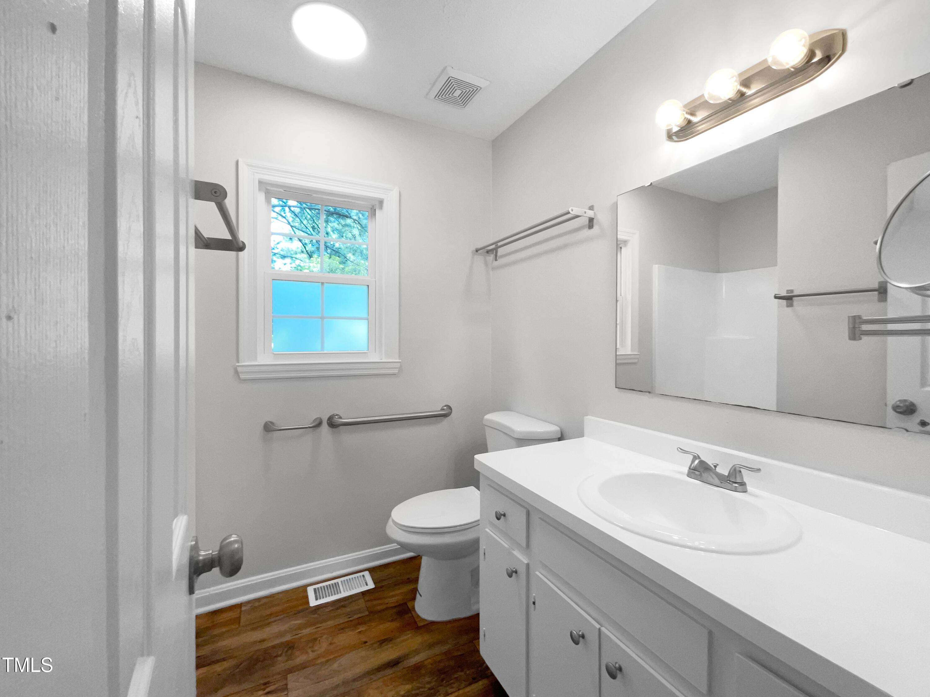 1516 Clayton Road Fuquay-Varina, NC 27526 - Photo 17 of 17 a bathroom with a toilet a sink and mirror
