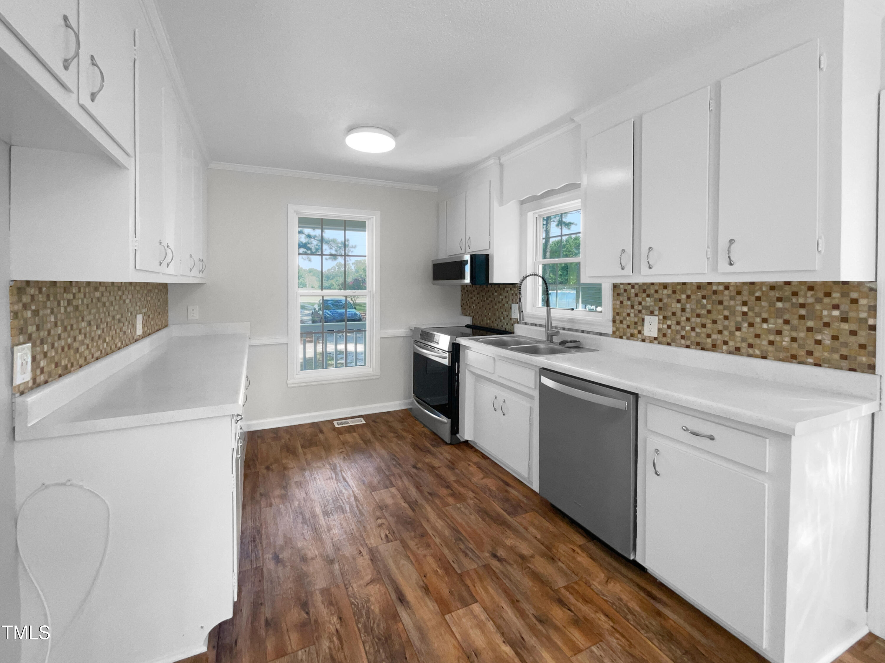 1516 Clayton Road Fuquay-Varina, NC 27526 - Photo 6 of 17 a kitchen with granite countertop white cabinets and white appliances