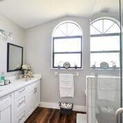 6216 Mullin Street Jupiter, FL 33458 - Photo 11 of 14 a bathroom with a granite countertop sink a large mirror and a window