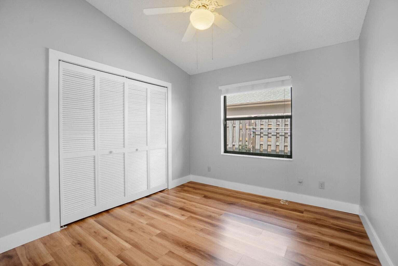 6216 Mullin Street Jupiter, FL 33458 - Photo 12 of 14 a view of an empty room with wooden floor and a window