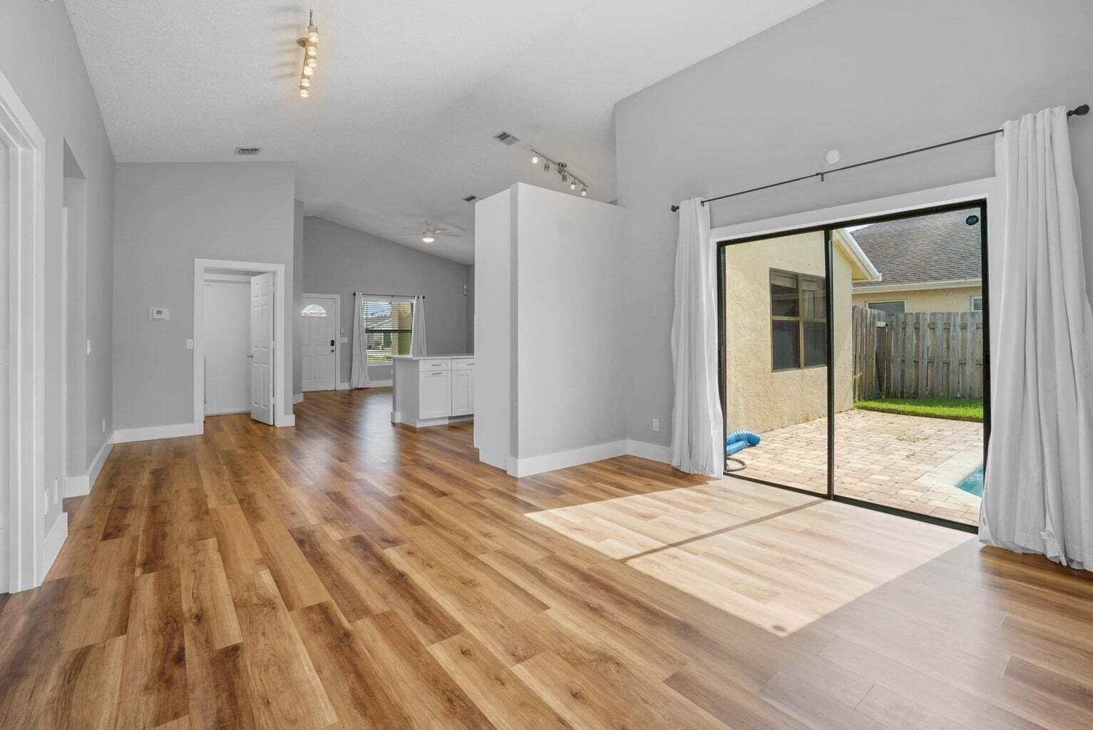 6216 Mullin Street Jupiter, FL 33458 - Photo 5 of 14 a view of a room with wooden floor