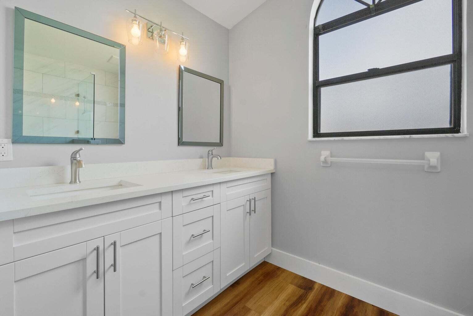 6216 Mullin Street Jupiter, FL 33458 - Photo 9 of 14 a bathroom with a sink and a mirror