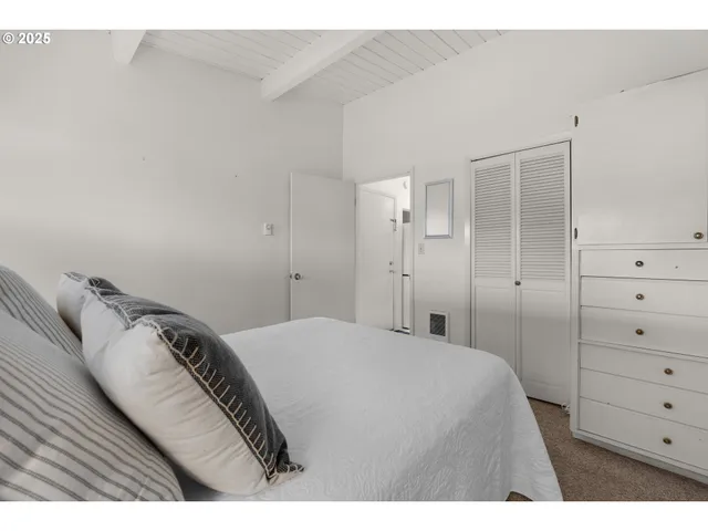 a bedroom with a bed and a mirror