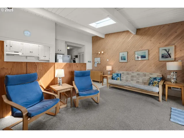 a living room with furniture a rug and a table