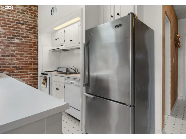 a kitchen with stainless steel appliances a refrigerator and a stove
