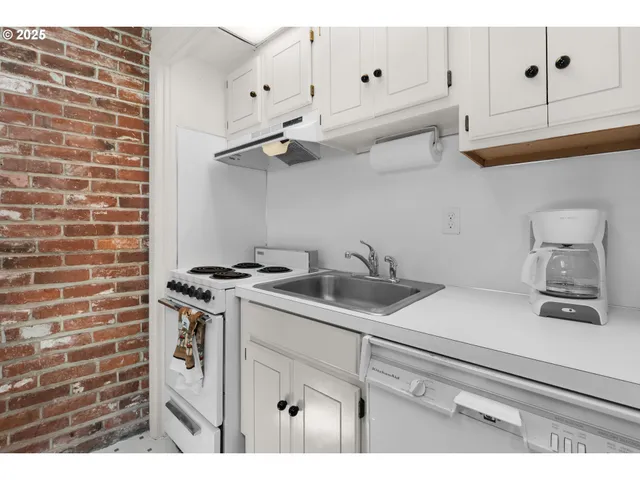 a kitchen with cabinets and appliances
