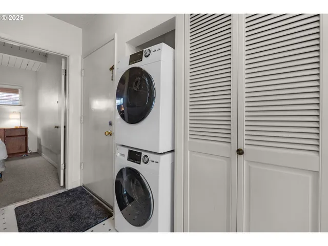 a view of a hallway with washer and dryer