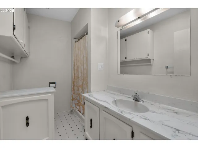 a bathroom with a granite countertop sink a toilet and a mirror