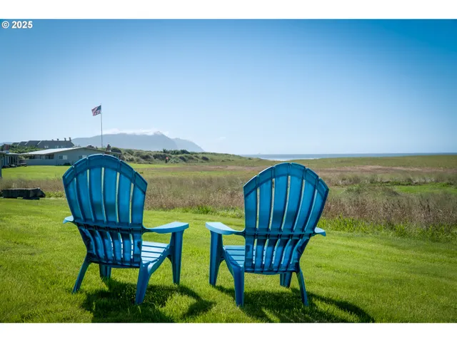 a view of a chair and table on the garden