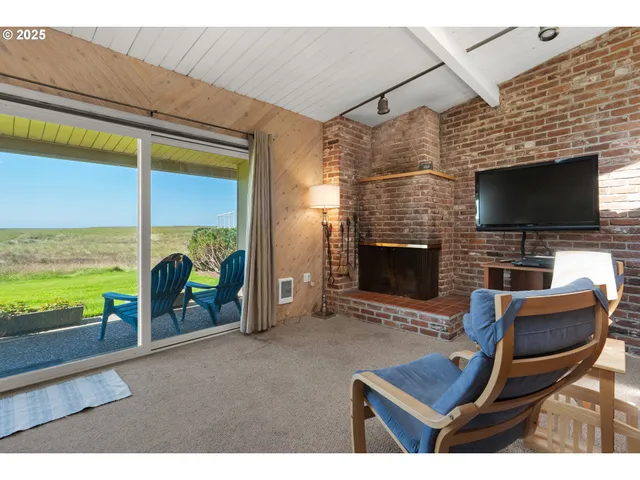 a living room with fireplace furniture and a flat screen tv