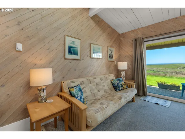 a living room with furniture and a floor to ceiling window