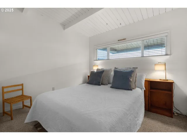 a bed room with a bed and a chair