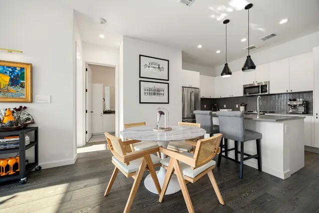 a living room with furniture large window and a table
