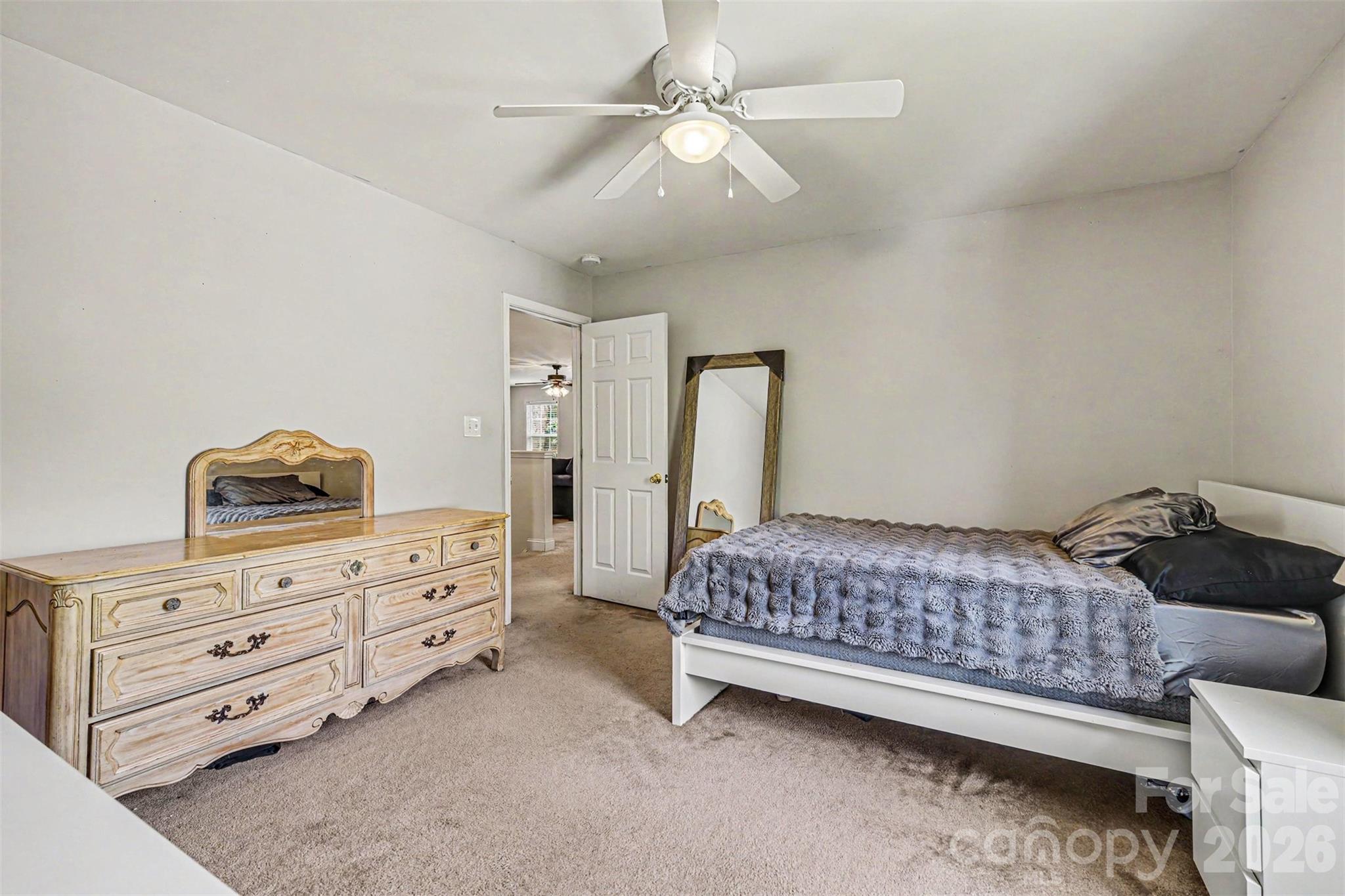 3035 Proverbs Court Monroe, NC 28110 - Photo 24 of 30 a bedroom with a bed and a dresser