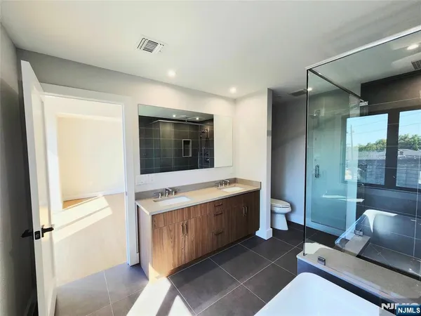 a living room with a couch and a stove next to a window