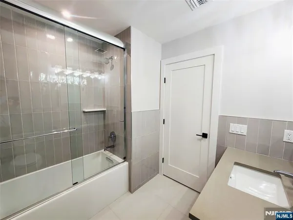 a bathroom with a tub a sink and shower